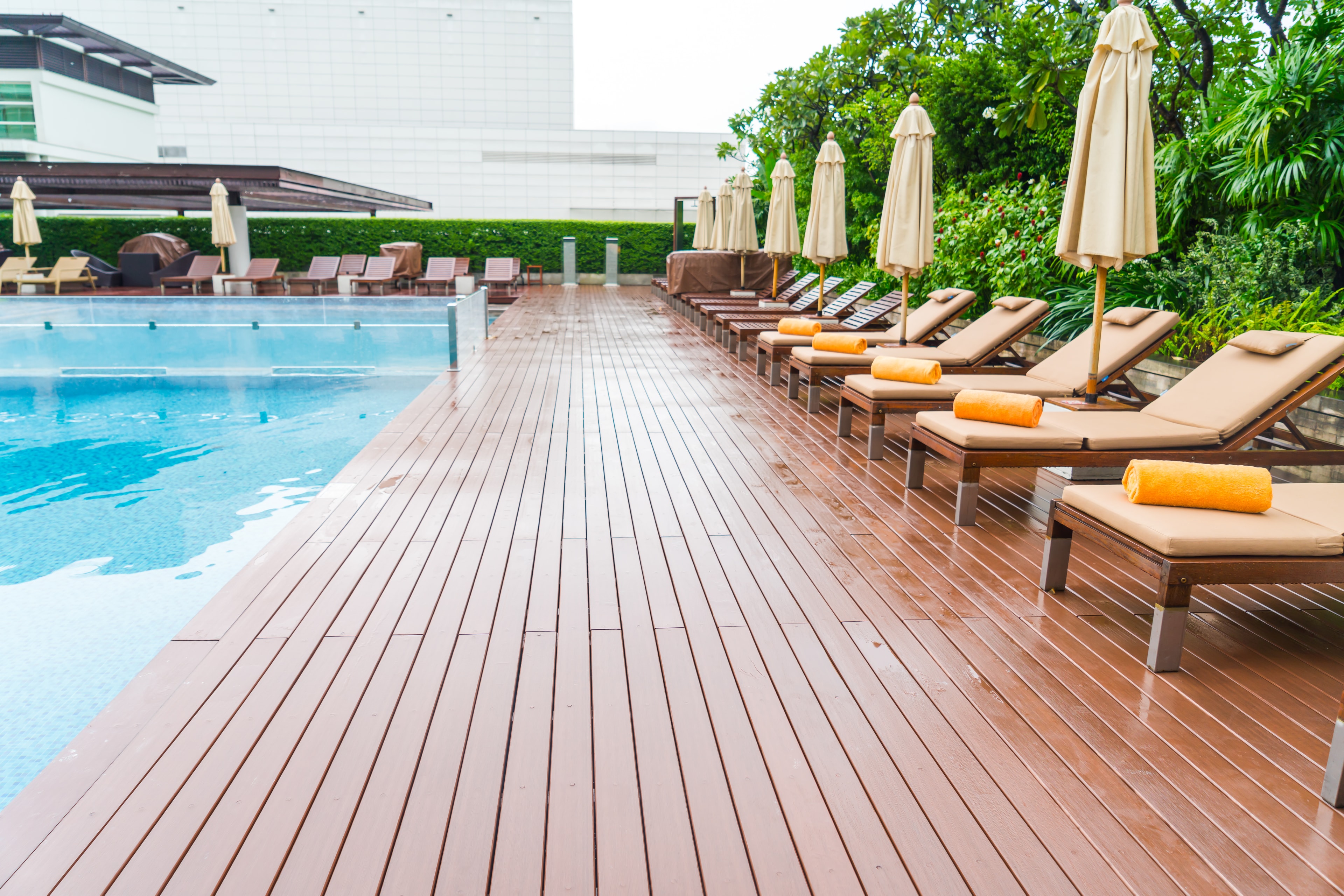 Luxury pool deck with hardwood decking and lounge chairs